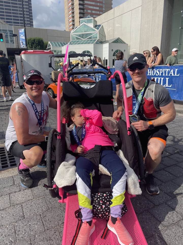 Aryeh Goldman with an adaptive racing chair at the Hospital Hill Half Marathon.